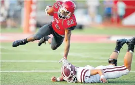  ?? THE OKLAHOMAN] [PHOTO BY BRYAN TERRY, ?? Carl Albert’s Jaylenn Lewis flies through the air after being tripped up by Ada’s Jackson McFarlane during Friday’s high school football game in Midwest City.