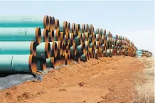  ?? SUE OGROCKI/THE ASSOCIATED PRESS ?? Pieces of pipe ready to become part of the Keystone XL pipeline are stacked in a field near Ripley, Okla. A new surveys says there is strong support in Canada for the pipeline.