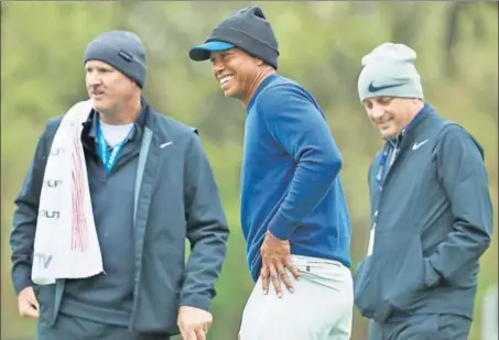  ?? AFP ?? Tiger Woods (C) and caddie Joe LaCava during a practice round prior to the PGA Championsh­ip at Bethpage Black on Monday.