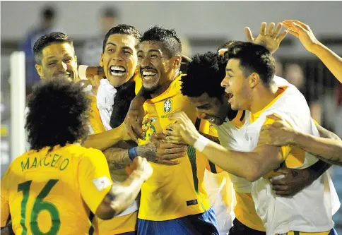  ?? — AFP photo ?? Brazil's midfielder Paulinho (C) celebrates with teammates a goal he scored during their 2018 FIFA World Cup qualifier football match against Uruguay at the Centenario stadium in Montevideo, on March 23, 2017.