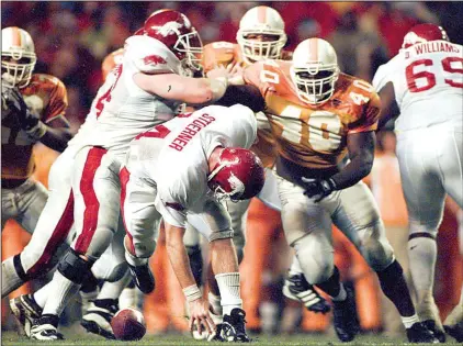  ?? Arkansas Democrat-Gazette/DAVID GOTTSCHALK ?? Arkansas quarterbac­k Clint Stoerner fumbles in the fourth quarter against Tennessee in 1998. The top-ranked Volunteers recovered with 1:43 remaining and rallied to avoid the upset, taking a 28-24 victory en route to winning the national title. “We had...