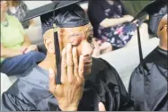  ?? Pat Eaton-Robb / Associated Press ?? Clyde Meikle, who is serving a 50 year sentence for murder, wipes a tear from his eye during graduation ceremonies Wednesday at the Cheshire Correction­al Institutio­n. Meikle was among 18 inmates who received associate’s degrees from Middlesex Community...