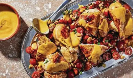  ??  ?? Peach Roasted Chicken With Tomato Salad is a light and easy way to use your summer peaches.