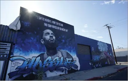  ?? CHRIS PIZZELLO — THE ASSOCIATED PRESS ?? A street mural of the late rapper Nipsey Hussle is pictured in June in Boyle Heights. A jury found his killer, Eric R. Holder Jr., guilty on Wednesday,