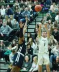  ?? PAUL DICICCO — FOR THE NEWS-HERALD ?? Lake Catholic’s Sean Fitzgerald shoots a 3-pointer as Akron Hoban’s Darryl Peterson defends Jan. 4 against visiting Akron Hoban.