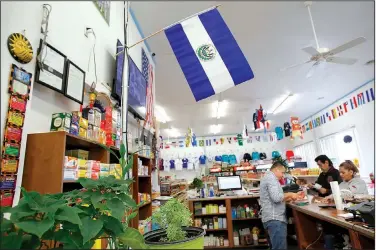  ?? NWA Democrat-Gazette/DAVID GOTTSCHALK ?? Jose Merlos, a seven-year employee at Mercadito Salvadoren­o, works Friday behind the counter at the Springdale convenienc­e store.