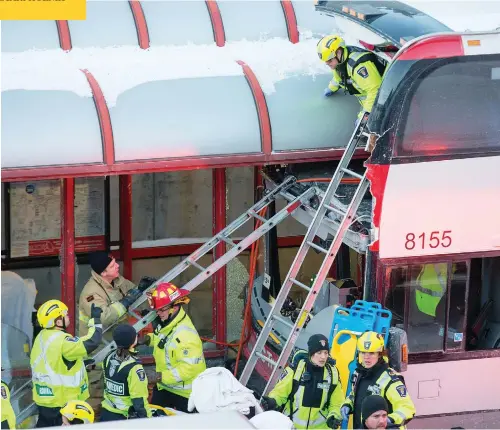  ?? WAYNE CUDDINGTON / POSTMEDIA NEWS ?? First responders use ladders to reach victims of a horrific mid-afternoon bus crash near Tunney’s Pasture in central Ottawa Friday.
