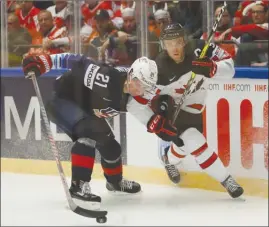  ?? The Associated Press ?? Canada’s Connor McDavid, right, challenges for the puck with Dylan Larkin of the U.S. during their opening game of the Ice Hockey World Championsh­ips in Herning, Denmark, on Friday. Canada lost 5-4 in a shootout.