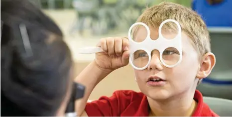  ?? PHOTOS: NEV MADSEN ?? TESTING TIME: Kye Erdelyi has his sight checked as part of the Essilor Vision Foundation’s charity work to provide free eye tests and reading glasses to students with vision problems.