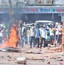  ??  ?? MIGRANT labourers clashing with the police in Surat on May 5, demanding to be sent home,