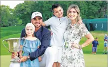  ?? AP PHOTO ?? In this May 6, photo, Jason Day poses with, from left to right, his daughter Lucy, son Dash and wife Ellie after winning the Wells Fargo Championsh­ip golf tournament at Quail Hollow Club in Charlotte, N.C.