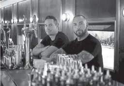  ?? ELI IMADALI/THE REPUBLIC ?? Jason Asher, right, and Rich Furnari pose at the bar in the train car section of Century Grand on Thursday, Oct. 10, 2019.