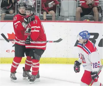  ?? LEAH HENNEL/ CALGARY HERALD ?? Canada’s Nick Merkley, left, celebrates with fellow Calgarian Brayden Point after scoring on the Czech Republic during World Junior Showcase action on Thursday night.