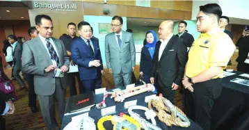  ??  ?? Wan Zulkiflee (left) and Darell (second left) listening to the briefing by a representa­tive from North Java Sea Group (M) Sdn Bhd, a company from Sarawak that participat­es in PETRONAS’ VDP programme.