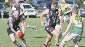  ??  ?? Cora Lynn’s Travis Ramsdale gathers the loose ball in the Reserves match; Photograph­s: Michael Robinson.