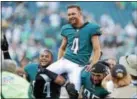  ?? JOHN BLAINE/ FOR DFM ?? Eagles kicker Jake Elliott (4) is carried off the field by teammates Kamu GrugierHil­l (54) and Mychal Kendricks (95) after hitting a 61-yard field goal as time expired to beat the Giants on Sunday afternoon.