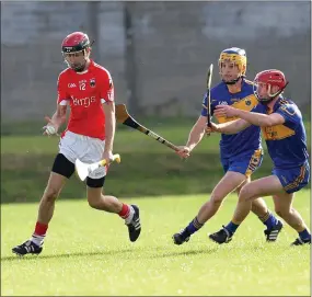  ??  ?? Glenealy’s Enan Glynn looks to avoid Carnew’s Andrew Hughes and Oisin Furlong during the SHc clash in Joule Park, Aughrim. Photo: Joe Byrne