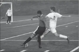  ?? STAFF PHOTO BY TED BLACK ?? North Point High School junior Zander Barrow looks to get past McDonough senior Jake Burgess in the second half of Tuesday’s Southern Maryland Athletic Conference boys soccer game. The Rams scored first, but Barrow and the host Eagles cruised to a 6-1 victory.