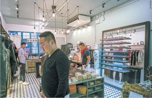  ??  ?? LEFT Customers browse locally designed fashion goods in an independan­t shop in Hong Kong. BELOW Creations by start-up retailer Grana in one of their shops.