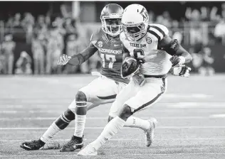  ?? Tony Gutierrez / Associated Press ?? A&M defensive back Donovan Wilson (right) was poised to make some noise in his senior season in 2017, but a fractured foot suffered against UCLA in the opener shelved him for the year.