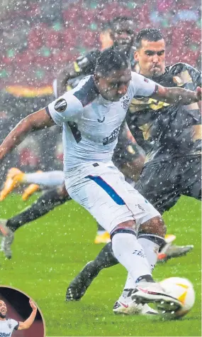  ??  ?? Alfredo Morelos toiled a bit in the Liege rain and Kemar Roofe (inset), who came on as a sub and