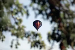  ??  ?? A hot air balloon floats over Mill Creek Park in Marysville on Aug. 5. The All Ohio Balloon Fest took to the skies the following weekend in Marysville.