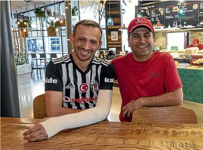  ?? STACY SQUIRES/STUFF ?? Kasim Canli, right, searched for many hours to find his friend and business partner Temel Atacocugu after the mosque attack.