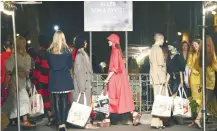  ??  ?? Models hold shopping bags at the end of the Sonia Rykiel Spring-Summer 2019 Ready-to-Wear collection fashion show.