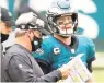  ?? PHOTO APFILE ?? Eagles coach Doug Pederson talks with quarterbac­k Carson Wentz (11) during a game against the Bengals. Pederson hasn’t considered benching Wentz, but could change his mind if Wentz continues to struggle.