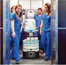  ??  ?? Opposite page: A Built Robotics employee checks the robotic control systems on one of the company's excavators, which allow them to work without an operator. Right: At Medical City Heart Hospital in Dallas, nurses work with Moxi, a robot that performs tasks that take nurses away from patients, such as fetching supplies and delivering lab samples