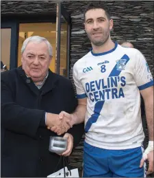  ??  ?? Bryan Sheehan accepts the Man of the Match award from sponsor Padraig Fogarty after the South Kerry SFC Final in Con Keating Park, Cahersivee­n last Saturday.