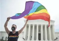  ?? CHIP SOMODEVILL­A/ GETTY IMAGES ?? Joseph Fons celebrates in Washington on Monday after the U.S. Supreme Court ruled that workplace anti-bias laws apply to
LGBTQ people.