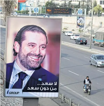 ?? REUTERS ?? Posters depicting Saad al-Hariri, who announced his resignatio­n as Lebanon’s prime minister from Saudi Arabia, is seen at airport highway in Beirut, Lebanon on Sunday.