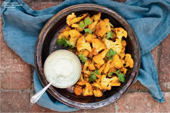  ??  ?? Spiced cauliflowe­r nuggets with coriander yoghurt sauce.
Grow salad crops in pots over winter as the soil in containers will be warmer and have better drainage than that in the garden.