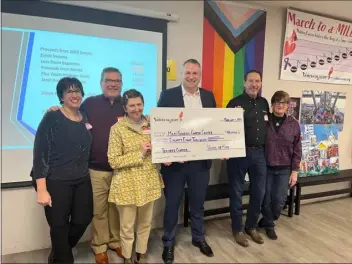  ?? COURTESY OF VOICES OF HOPE ?? From left, Voices of Hope Treasurer Jean Chastain, VOH founder and President Greg Chastain, Termeer Center Nurse Director Casandra Mcintyre, Termeer Center Director Dr. Dejan Juric, VOH Vice President Ed Siegal and VOH Artistic Director Dana Siegal pose with a check for $88,000, which VOH raised to donate to the center in 2022. The group, which raises money for cancer research, is now $21,000away from their goal of $1million.