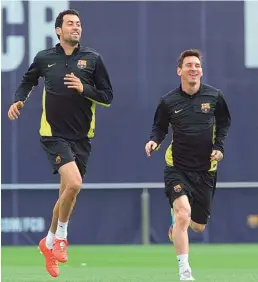  ?? — AFP ?? Barcelona midfielder Sergio Busquets (left) and forward Lionel Messi jog during a training session at their Joan Gamper training facility in Sant Joan Despi, near Barcelona, on Monday, eve of the first leg of their UEFA Champions league quarterfin­al...
