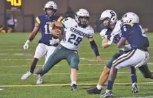  ?? STAFF PHOTO BY C. B. SCHMELTER ?? Silverdale Baptist Academy’s Turner Junkins stumbles forward for extra yards during Friday night’s game at Chattanoog­a Christian. Both teams will compete in the playoffs starting next week.