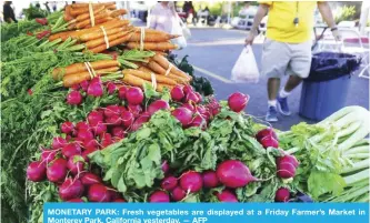  ?? — AFP ?? MONETARY PARK: Fresh vegetables are displayed at a Friday Farmer’s Market in Monterey Park, California yesterday.