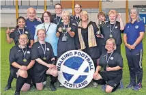  ?? ?? Champions It was all smiles when lifting the trophy. Photo: Walking Football Scotland