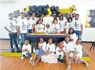  ?? CHRISTOPHE­R THOMAS PHOTOS BY ?? Ivan Sterling (centre, seated) in a group shot with members of his family during a celebrator­y dinner to mark his 100-year milestone at the Meet Conference and Event Centre in Montego Bay, on Sunday, January 14.