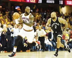  ?? (Reuters) ?? CLEVELAND CAVALIERS forward LeBron James (left) takes off on a fast-break after stealing the ball from Toronto Raptors forward P.J. Tucker (right) for two of his game-high 39 points in the Cavs’ 125-103 home victory on Wednesday night in Game 2 of the...