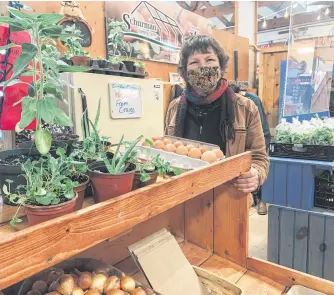  ??  ?? Judy Loo sells her produce at a farmers market. Loo, a farmer at family-owned Springwill­ow Farm in Kensington, P.E.I., says a UN conference she attended on agricultur­al diversity and sustainabi­lity opened her eyes to food waste in Canada. CONTRIBUTE­D