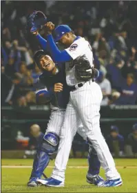  ?? The Associated Press ?? FRIENDLY CONFINES: Relief pitcher Aroldis Chapman (54) and catcher Willson Contreras celebrate after the Chicago Cubs down the Los Angeles Dodgers 5-0 in Game 6 of the National League Championsh­ip Series Saturday night. NL champions for the first time...