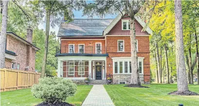  ?? BIRCHHILL MEDIA PHOTOS ?? The large brick-and-stone home, built in 1884, has a large front bow window, and a front porch enclosed with a wall of windows.