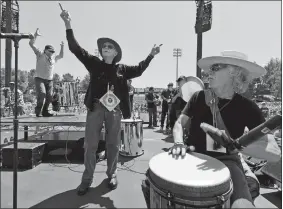  ?? DAMIAN DOVARGANES, FILE/AP PHOTO ?? In this May 18, 2012, photo Grateful Dead drummer Mickey Hart, left, Remo Belli, founder and CEO of Remo Inc., center, and John Densmore, the drummer of the rock band The Doors, celebrate to the beat of “Rock the Rhythm, Beat the Odds,” a giant drum circle event at the College of the Canyons Cougar Stadium in Santa Clarita, Calif., Remo, the pioneer of the world’s first synthetic drumhead that built the beat for a half century of rock ’n’ roll, pop and more, died last week at age 88.