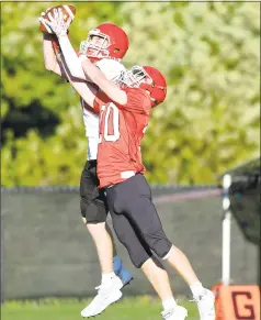  ?? Matthew Brown / Hearst Connecticu­t Media ?? New Canaan’s Wyatt Wilson (back) and Will Rechterman­n fight for a pass during the 11th Annual Brian Wilderman Memorial Red and White game at Dunning Stadium in New Canaan on Friday.