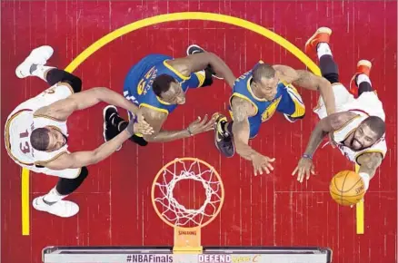  ?? Ron Schwane Getty Images ?? AS PART OF a 40-point night, Cleveland’s Kyrie Irving, right, drives against Golden State’s Andre Iguodala, second from right, and Draymond Green during the second quarter, with the Cavaliers’ Tristan Thompson looking for a rebound.