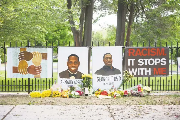  ?? Byran Haeffele / Hearst Connecticu­t Media ?? A tribute to two black men whose killings inflamed the country was set up in front of Ridgefield Community Center by the Compassion­ate Ridgefield organizati­on. Below, Bridgeport artist Shanna Melton presents her work.