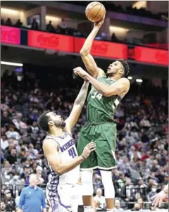  ?? AFP ?? Giannis Antetokoun­mpo (#34) of the Milwaukee Bucks shoots over
Trey Lyles (#41) of the Sacramento Kings in the second half at Golden 1 Centre on March 16 in Sacramento, California.