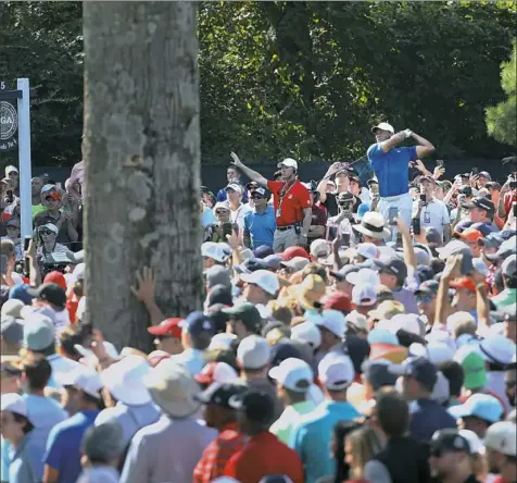 ?? Jamie Squire/Getty Images ?? Tiger Woods played his way into contention Saturday and the crowds swelled. Here, he tees off from No. 15 at Bellerive.